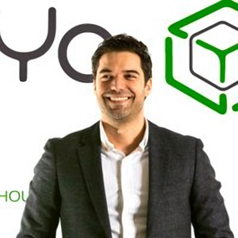 Raymond of Vareya, smiling in front of the VareYa brand backdrop.